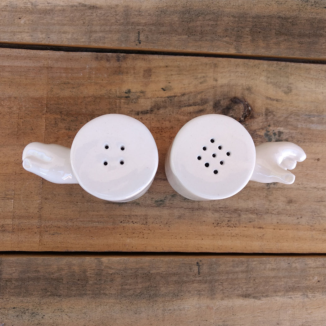 Detalle salero pimentero cerámica artesanal con manos como asas vista superior