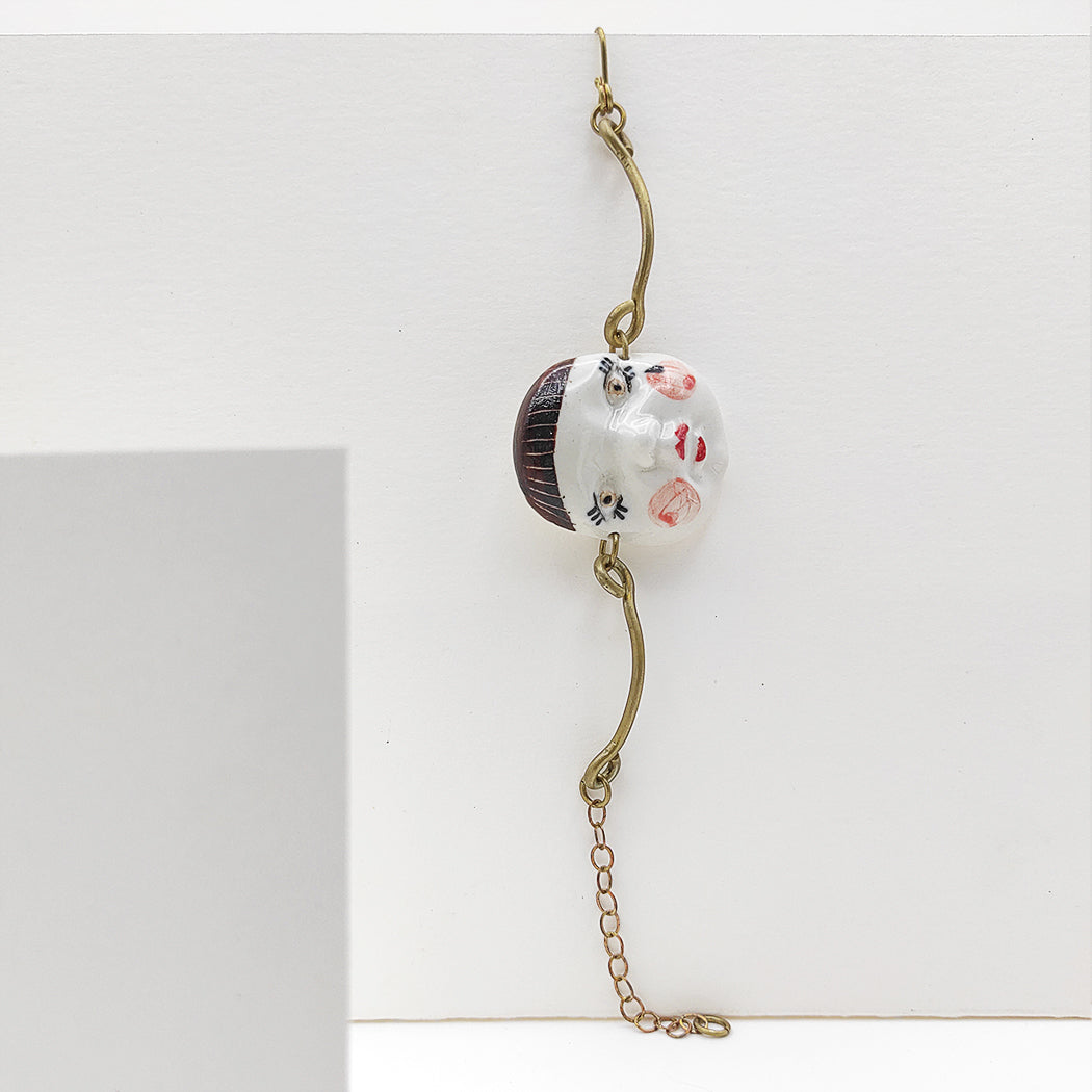 Pulsera ajustable caritas con flequillo  porcelana